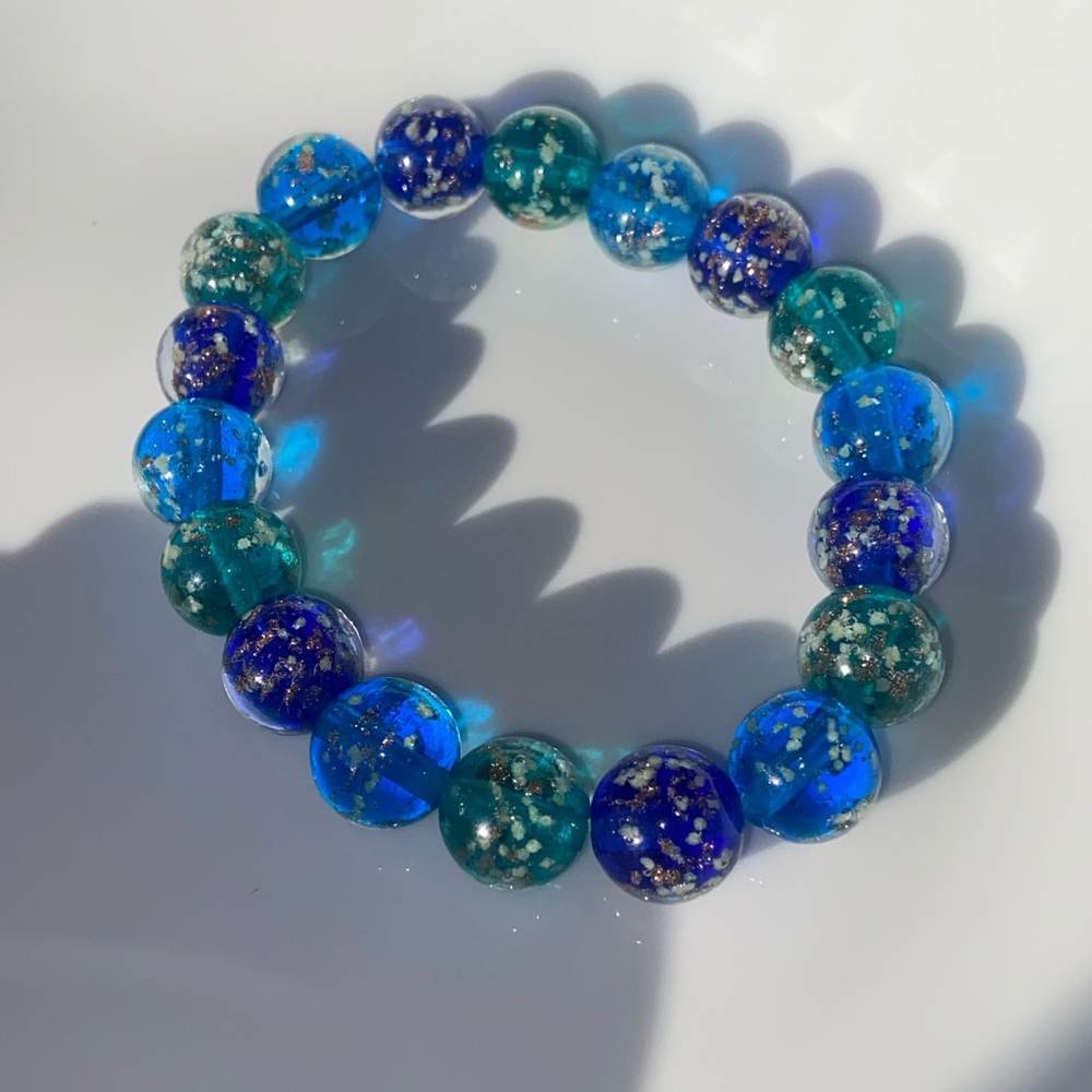 Beautiful handmade blue glass beads bracelet with golden reflections